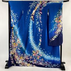 This beautiful furisode (long-sleeved kimono) features beautifully designed flowers that look like the Milky Way. The transition from blue to dark blue is a piece that expresses a truly Japanese beauty. Height 169.5cm Length from sleeve to sleeve 68cm Sleeve length 113.5cm Sleeve width 34cm Front width 25cm Back width 30.5cm Material: Pure Silk Condition:Please see photos. ☆ Furisode" symbolizes youthfulness and glamour, and it is considered a garment to make oneself look beautiful. It is characterized by gorgeous designs with traditional Japanese patterns, expressing traditional Japanese culture and aesthetics. Kimono makes your life even more beautiful. ☆ Thank you for visiting my page. My store owns a lot of unique items that you won't see in other stores. You won't regret it! Please se Luxury Long Sleeve Traditional Kimono, Luxury Traditional Long Sleeve Kimono, Furisode Kimono, Kimono Japanese, Long Sleeve Kimono, Photo Care, Kimono Vintage, Wedding Kimono, Luxurious Wedding