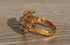 The Calley Antique Engraved Georgian Diamond Cocktail Ring in Yellow Gold. Crafted in 18 karat yellow gold, this ring features a 1.13 carat chunky old mine cushion cut center diamond. The diamond has an approximate Gemological Institute of America clarity grade of VS2 and a color grade of I. Surrounding the center is 1.20 carats of chunky old mine cut diamonds. Intricate engraving details finish this ring making it truly one of a kind. Well preserved original engraving can be found on the inner Antique Yellow Gold Ceremonial Rings, Luxury Yellow Gold Victorian Engraved Ring, Victorian Yellow Gold Rings With Polished Finish, Victorian Yellow Gold Carved Rings, Victorian 14k Yellow Gold Diamond Ring, Filigree Engagement Ring, Diamond Cocktail Ring, Ring Making, Antique Diamond Rings