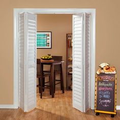 an open door leading to a kitchen and dining room