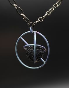 Fabricated with titanium wire, created to look like the planets orbiting the sun. Titanium is super light weight and very durable. Color is achieved by anodizing the metal (using electricity). Bead is steel mesh. Chain is steel. Clasp is magnetic. Pendant is 1.25" H x .5" Deep. The Planets, Steel Mesh, Pendant Necklaces, Jewelry Necklace Pendant, Electricity, Accessory Gift, Jewelry Necklaces, Display Homes, Mesh