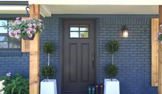 a front door with two planters on each side