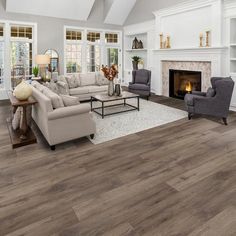 a living room filled with furniture and a fire place in the middle of a room