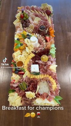 a very long table covered in lots of different types of meats and cheeses