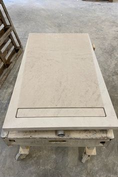 a white table sitting on top of a wooden pallet next to a stack of crates