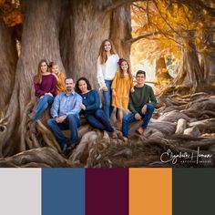 an image of a family posing for a photo in the woods with trees and leaves