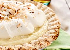 a pie topped with whipped cream and nuts