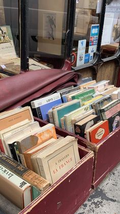 an old suitcase filled with books on the sidewalk