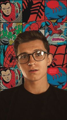 a man with glasses standing in front of comic panels