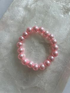 COLOR - PINK This bracelet is handmade with plastic pearl beads and stretchy cord. The diameter (un-stretched) is about 2.5 inches from one outside end to the other. Pink Beaded Round Pearl Bracelet, Pink Adjustable Pearl Stretch Bracelet, Adjustable Pink Pearl Stretch Bracelet, Pearl Beaded Bracelet, Pearl Rose, Pink Bracelet, Pink Pearl, Pearl Bracelet, Pearl Beads