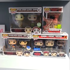 three pop - up figures are on display in the store