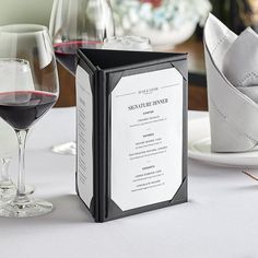 a table with wine glasses and menus on it