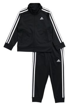 A trio of signature contrast stripes elevate the sporty appeal of this classic tracksuit made from warm and enduring poly-tricot Jacket has front zip closure Jacket has front welt pockets 100% polyester Machine wash, tumble dry Imported Adidas Sporty Tracksuit For Sports, Sports Tracksuit With Three Stripes And Long Sleeves, Adidas Black Outerwear With Three Stripes Branding, Adidas Black Track Jacket For Training, Adidas Long Sleeve Track Jacket With Three Stripes, Black Track Jacket With Three Stripes Branding, Sporty Adidas Tracksuit, Adidas Sportswear Tracksuit, Functional Black Adidas Track Jacket