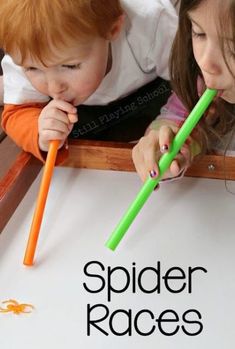 two young children are playing with their green and orange toothbrushes on the table