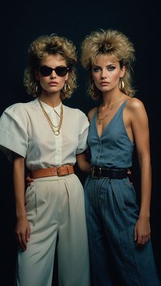 Two women in 80s fashion style with bold hairstyles, gold jewelry, high-waisted pants, and classic blazers. 1980s Woman Fashion, 80s Inspired Fashion Outfits, 1980s Womens Fashion 80s Style, Iconic 80s Fashion, 80s Futuristic Fashion, Classy 80s Fashion, 80s Fashion For Women Party, 80s Elegant Fashion, Rock And Roll Outfits 80's