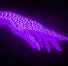 an image of a purple object that looks like it is flying through the night sky