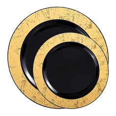 three black and gold plates stacked on top of each other in the shape of circles