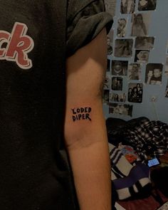 a man with a tattoo on his arm that says loaded diper in black ink