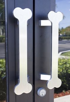 a close up of a door handle with a dog bone on the front and side