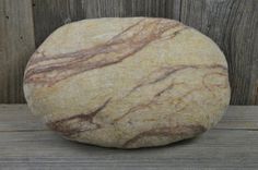 a rock sitting on top of a wooden table