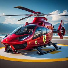 a red helicopter sitting on top of an airport runway