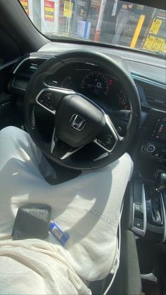 the interior of a car with a steering wheel and dashboard covered in a white cloth