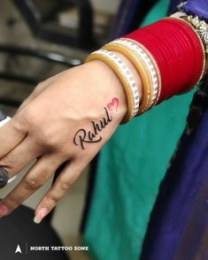 a woman's hand with the word radal written on it and two bracelets around her wrist