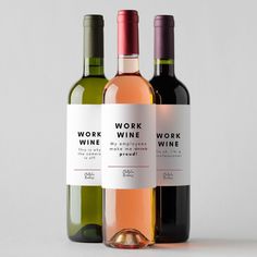 three bottles of wine sitting next to each other on a white surface with no one around them