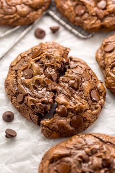 chocolate chip cookies are on top of parchment paper