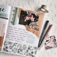 an open book with pictures and writing on the pages, next to a pen and some other items