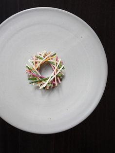 a white plate topped with a colorful piece of food