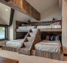 a bedroom with bunk beds and stairs in it