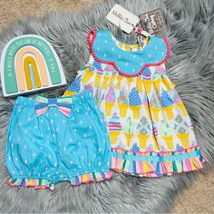 Nwt. Absolutely Adorable. Bright Colors, Bold Print Ruffles And Pom Pom Trim. Top Flares Out, Scalloped Collar, Back Buttons With Mj Logo Patch Near Bottom Hemline, Matching Bloomer Shorts, Fixed Bow With Elasticized Waistband. Size 6/12 Months Bin: K22 Playful Ruffled Sets For Playtime, Playful Playwear Sets For Spring, Playful Spring Playwear Sets, Playful Spring Sets For Playdate, Playful Sets For Playdate In Spring, Fun Multicolor Sleeveless Sets, Blue Cotton Set For Birthday, Cute Light Blue Sets For Playwear, Cute Multicolor Sleepover Sets