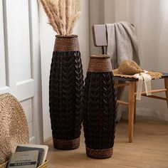 two brown vases sitting on top of a wooden floor