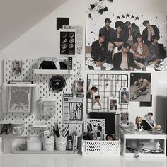 a white desk topped with lots of pictures and magnets