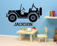 a child's room with a wall decal featuring a jeep