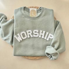 Our Worship crewneck sweatshirt is the perfect trendy minimalistic christian sweatshirt to declare your faith to the Lord! A great for your family, friends, or loved ones. - Sweatshirt is super soft and comfy! ♡  - Sweatshirt composition: 50% cotton, 50% polyester - All our sweatshirts run a unisex fit. They are naturally oversized, so we normally recommend your true size. But if you like a more baggy look, we recommend sizing up. - These letters are iron-on patched and is heat pressed, not embr Trendy Worship Leader Outfit, Inspirational Cotton Crew Neck Sweatshirt, Worship Sweatshirt, Worship Team Outfits, Worship Leader Outfit, Made To Worship, Worship Team, Outfit Check, Christian Sweatshirt