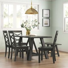 a dining room table with four chairs around it