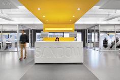 an office lobby with yellow and white accents