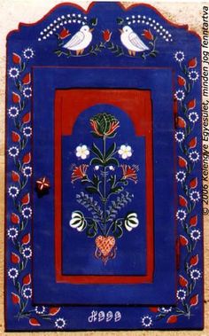 a blue and red painting with two birds sitting on it's side, surrounded by flowers