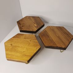 three pieces of wood sitting on top of a white table next to another piece of wood