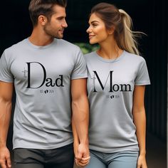 ABOUT OUR   Est. Mom and Dad Shirts. The perfect Pregnancy Announcement Gift.   👉 Unisex T-shirt - 100% Airlume combed and ringspun cotton  - Soft cotton and quality print make users fall in love with it over and over again.  - These t-shirts have-ribbed knit collars to bolster shaping. - Printed and shipped from the USA CARE INSTRUCTIONS - Wash inside out with like colors. - Tumble dry or hang to dry. - Try not to iron directly over the design. Iron if necessary!  HOW TO ORDER  1) Please, chec Pregnancy Announcement Shirts For Family, Family Matching White Maternity T-shirt, Mom And Dad Shirts, Christmas Gift For Parents, Mom And Dad Shirts Pregnancy, Maternity Family Matching T-shirt With Graphic Print, Pregnant Mom Shirts, Surprise Pregnancy Announcement, Dad Shirts