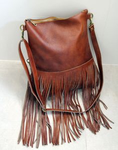 Bohemian fringe bag, cognac leather fringe bag, cognac brown boho bag, festival bag, leather crossbody, handmade leather bag This gorgeous bohemian style bag is crafted with a high quality suede leather and a cowchide leather. It has a top zip closure, and includes an inside pocket. It's cross body feature makes it suitable for a day or night occasion. Light in weight and unique. It is the perfect bag for every season. We use soft genuine leather. This bag is perfect as your everyday bag, which Brown Tassel Crossbody Shoulder Bag, Brown Crossbody Shoulder Bag With Tassels, Brown Leather Hobo Bag For Festival, Bohemian Shoulder Bag With Tassels For Fall, Festival Brown Hobo Bag With Fringe, Brown Fringe Hobo Bag For Festival, Festival Brown Fringe Hobo Bag, Brown Tasseled Hobo Bag, Brown Tasseled Crossbody Hobo Bag