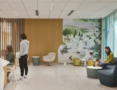 people sitting and standing in an office lobby