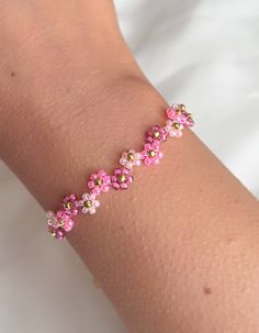 Pink Flower Beaded Bracelets For Summer, Spring Pink Jewelry With Colorful Beads, Pink Flower-shaped Beaded Bracelets, Pink Flower Beaded Bracelets Dainty Style, Pink Dainty Beaded Bracelets For Spring, Dainty Pink Beaded Bracelets For Spring, Pink Dainty Flower Beaded Bracelets, Dainty Pink Flower Beaded Bracelets, Rubber Band Crafts