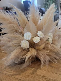 some white flowers and feathers on a table