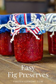 three jars filled with jam sitting on top of a wooden table