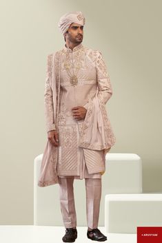 Make a Grand Statement on Your Special Day This Sherwani Design is available in two colours: Rose Gold (1st Pic) & Cream/Beige. Choose as per your liking. Step into luxury with a Handmade Sherwani / Achkan crafted from premium soft blended silk, velvet and cotton blends in a stunning Cream / Gold colour, offering both comfort and sophistication. Our diverse collection features designs to suit every taste: Classic Elegance: Choose a timeless Sherwani with intricate embroidery on the collar or cuf Nawabi Sherwani, Sherwani Design, Wedding Wear For Men, Cream Sherwani, Ethnic Wedding, Handmade Rose, Gold Work, Wedding Suits Men, Intricate Embroidery