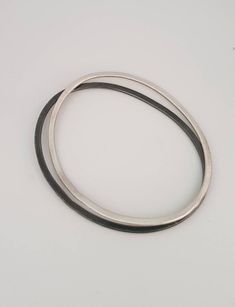 This is a beautiful delicate sterling silver bracelet . A minimalist oval bracelet in a matt finish. It is great to wear alone or stack it up. Each bangle is hand-crafted in my studio. This bangle was made with alot of love. This bracelet is a great gift for women and could be a great delicate bracelet or brides and bridesmaids. This listing is for a single dimensions: small: 7/5.5 cm medium:7.7/6 cm large: 8.2/6.5 cm -Sterling silver -Free shipping worldwide -Gift box If you wold like to see ot Minimalist Oval Bangle As A Gift, Minimalist Oval Bangle As Gift, Minimalist Oval Bangle Gift, Minimalist Oval Bracelets For Everyday Wear, Modern Silver Oval Bangle, Minimalist Sterling Silver Oval Bracelets, Minimalist Oval Sterling Silver Bracelets, Minimalist Sterling Silver Oval Bracelet, Minimalist Oval Sterling Silver Bracelet