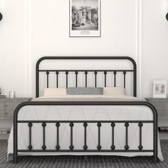 a black metal bed frame in a white bedroom