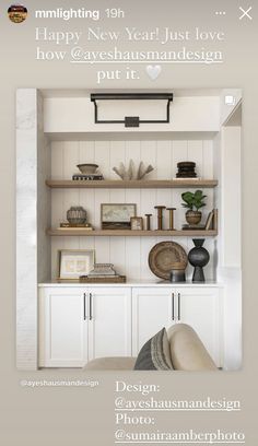 an open book shelf with books and other items on it, in front of a white wall